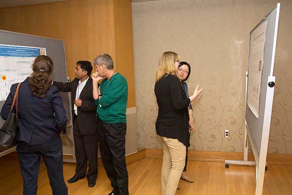 CPB Graduate student Shankar (left) with Symposium attendees during poster session.